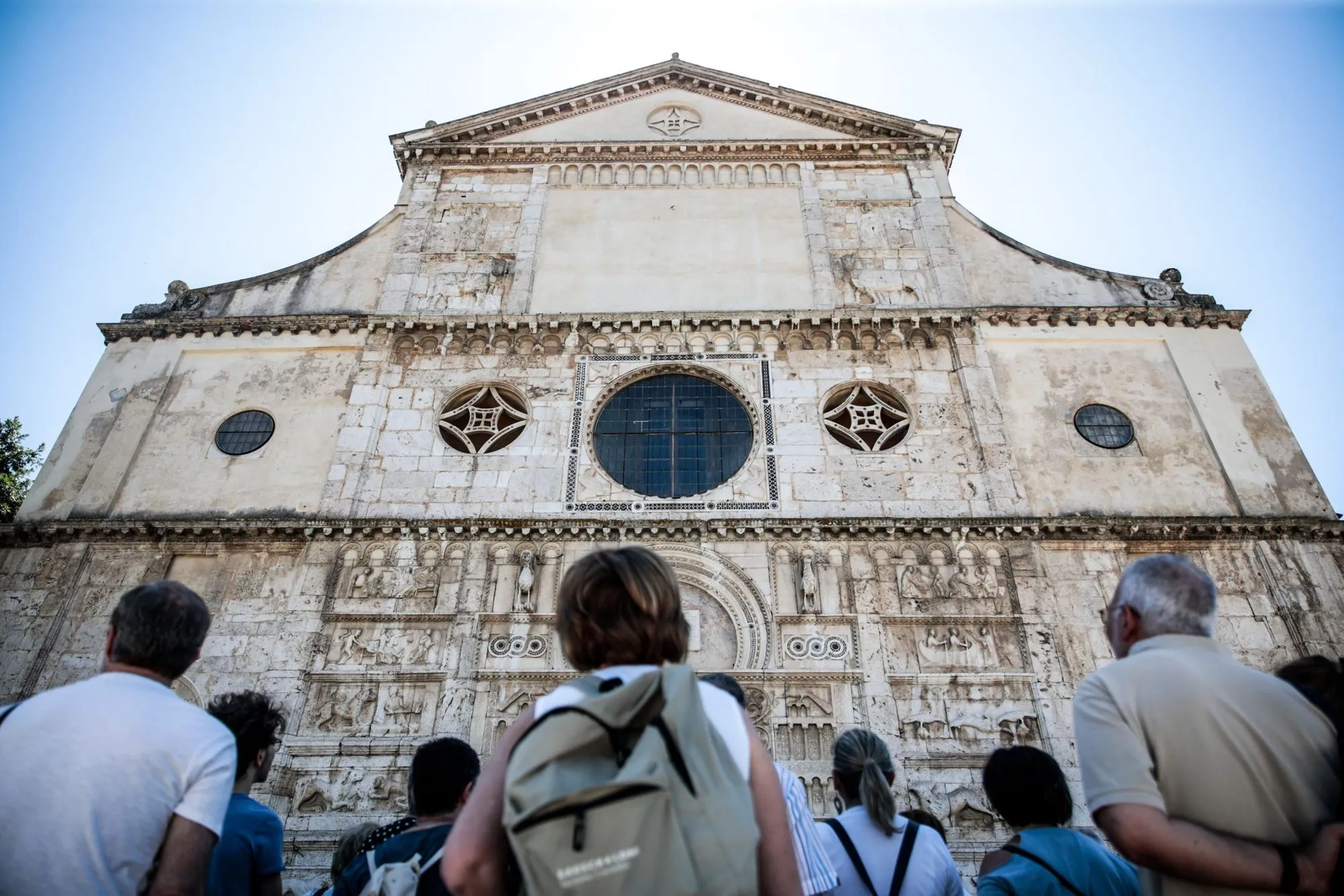 Visitors admire historic church facade during Festival di Spoleto
