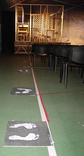Staged scene with footprints at Festival di Spoleto theatrical performance setup