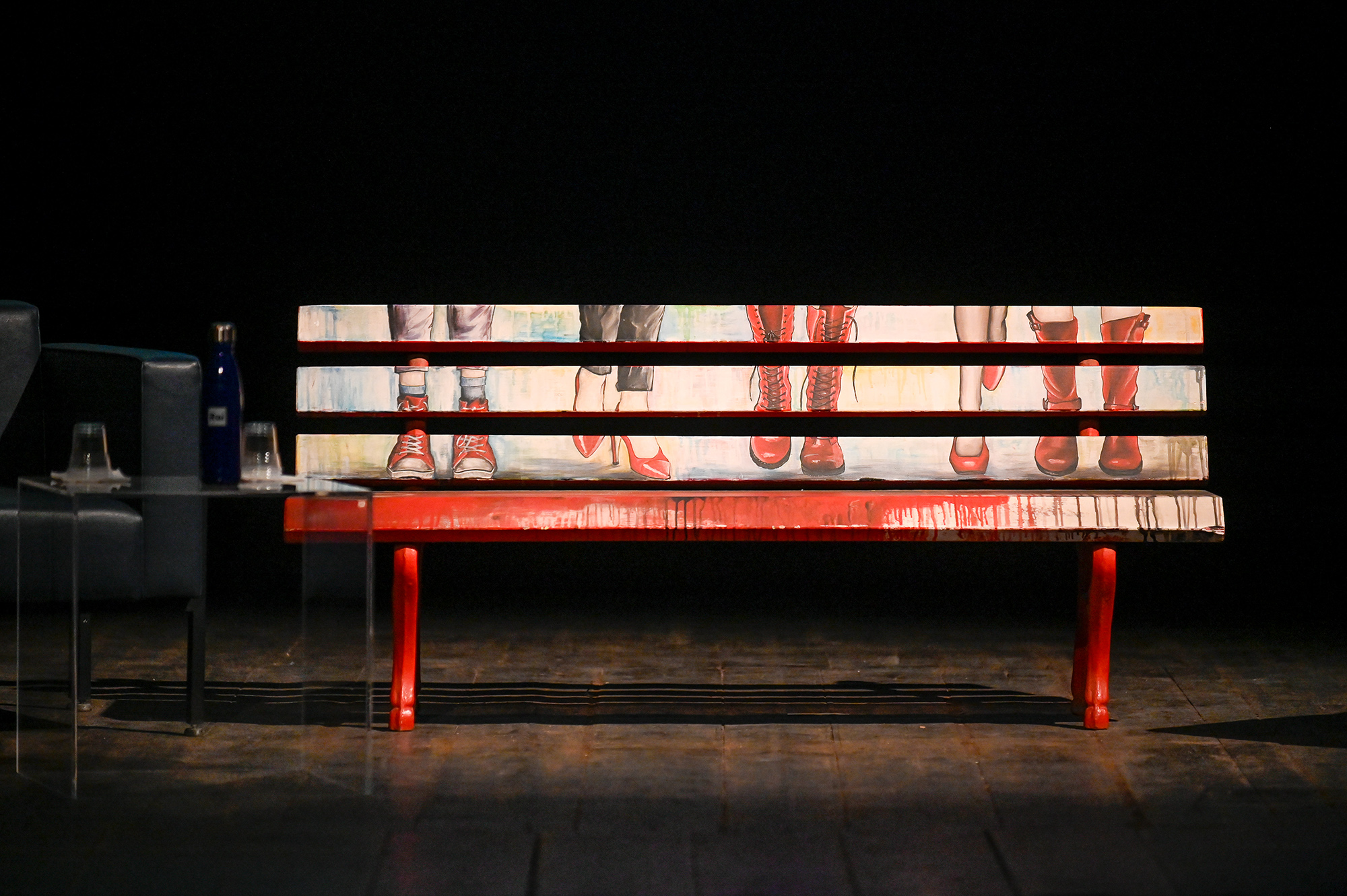 Festival di Spoleto art installation with red bench and fragmented shoe panels