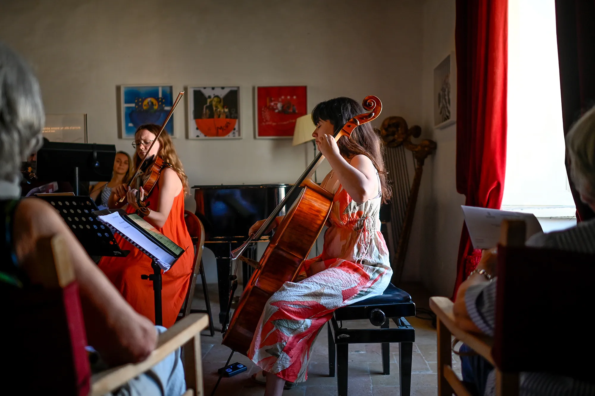 Musicians preparing for Festival di Spoleto, playing violin and cello indoors