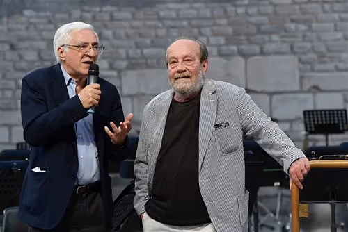 Two men speak on stage at Festival di Spoleto cultural event