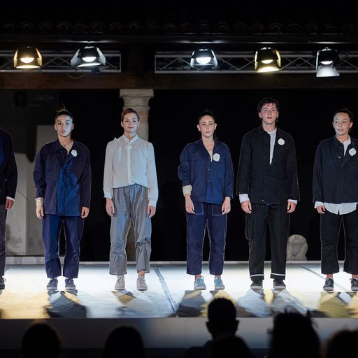 Performers on stage at Festival di Spoleto, showcasing minimalist fashion performance