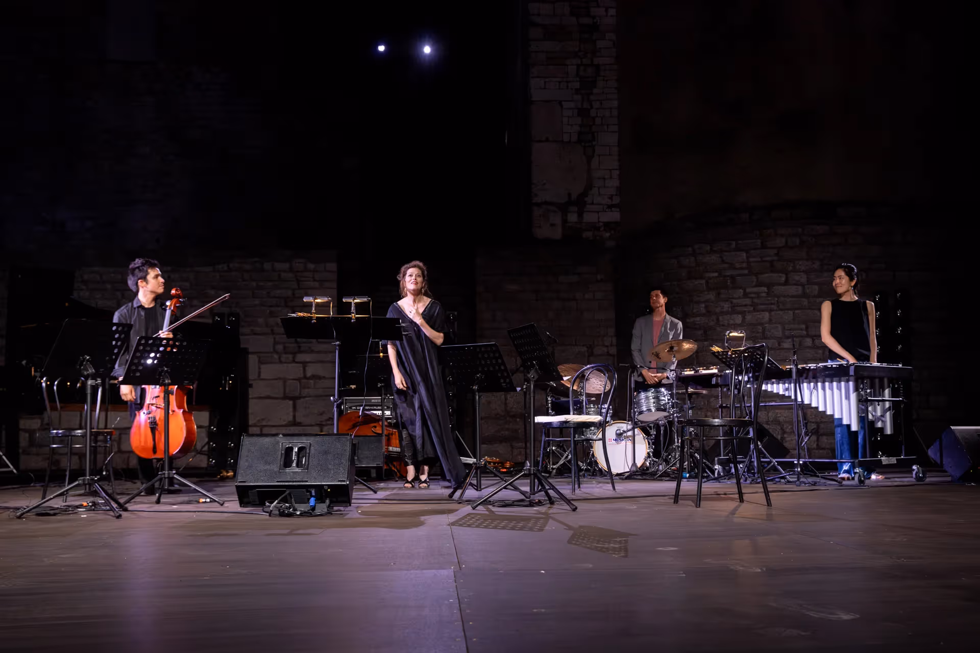 Musicians perform on stage at Festival di Spoleto, showcasing diverse instruments