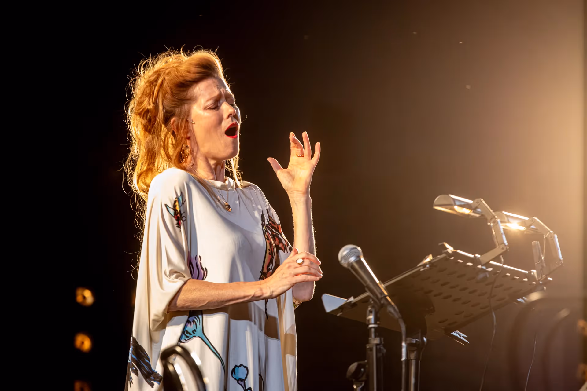 Passionate singer performing at Festival di Spoleto with dramatic stage lighting