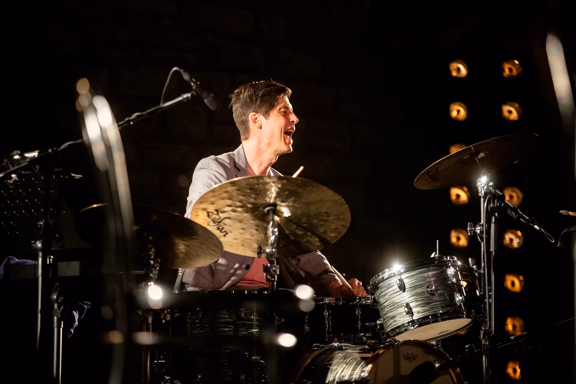 Intense drummer performing at Festival di Spoleto, passionately playing on stage