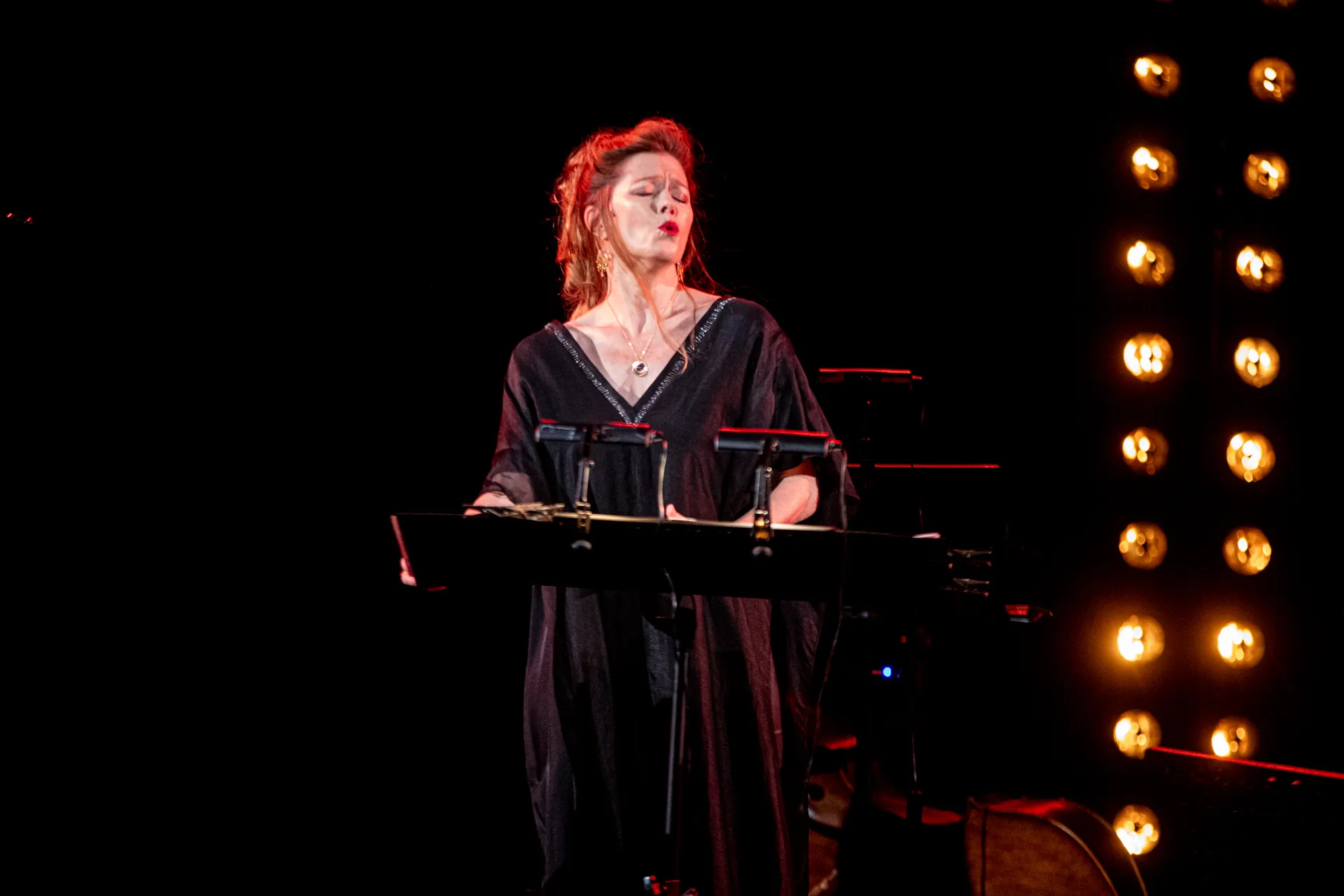 Passionate performer at Festival di Spoleto, singing with dramatic stage lighting
