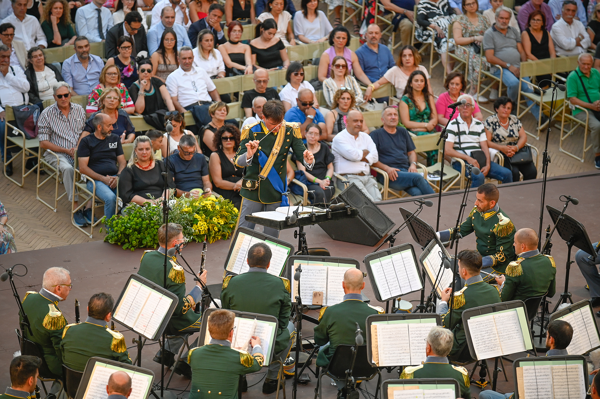 Military band performs at Festival di Spoleto, audience watches intently