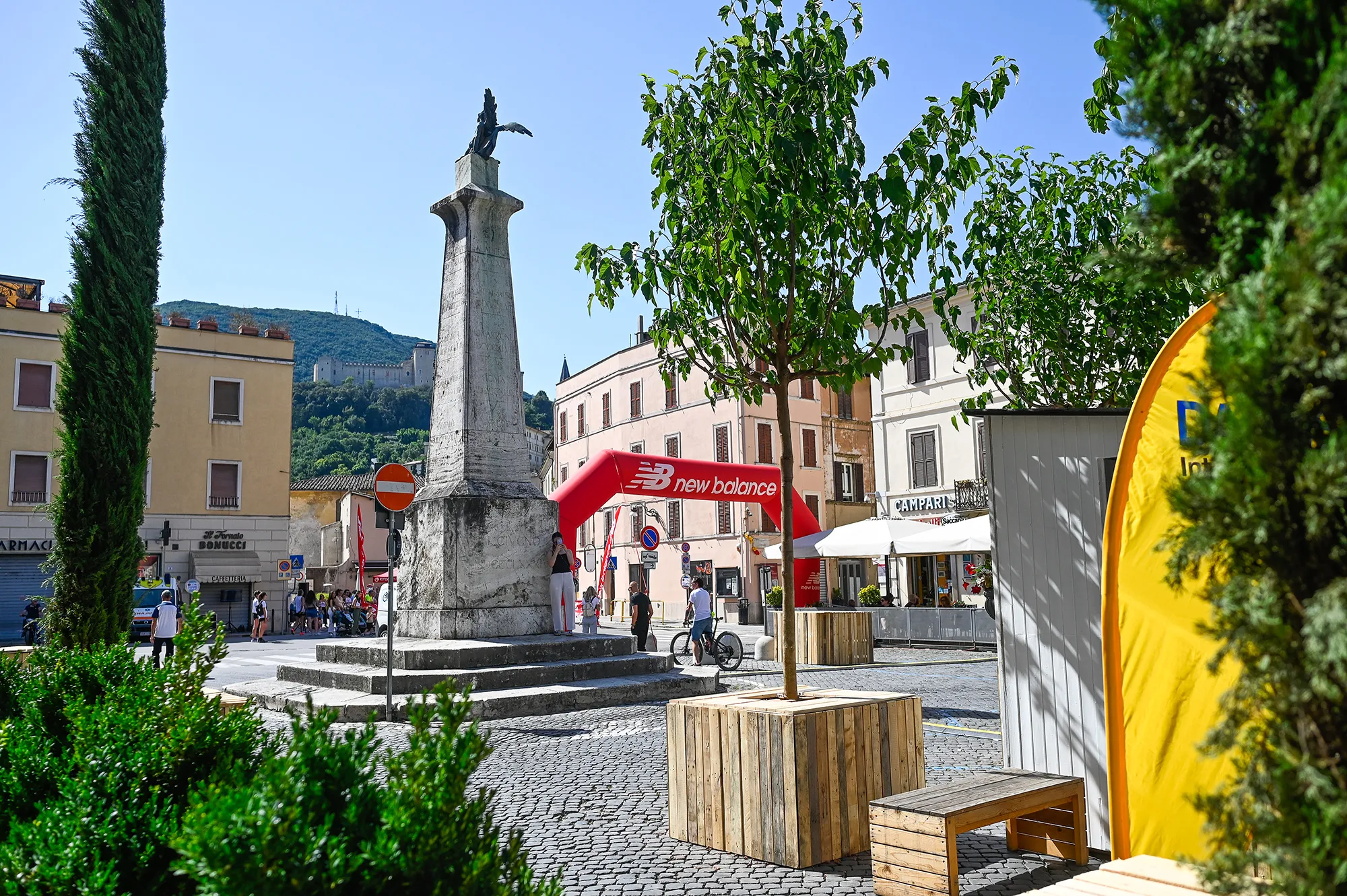 Festival di Spoleto historic square with monument, New Balance arch, and scenic backdrop