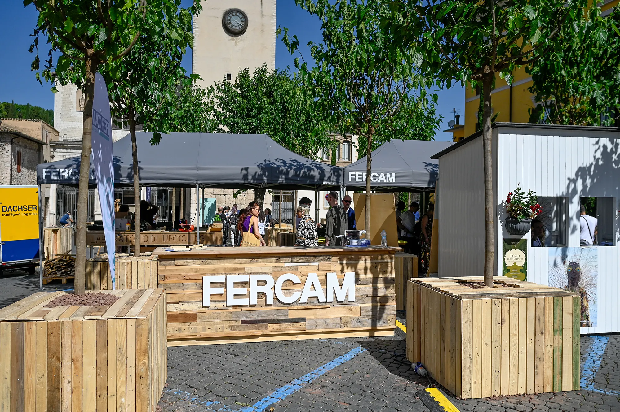 Fercam booth at Festival di Spoleto, showcasing wooden stands in historic square
