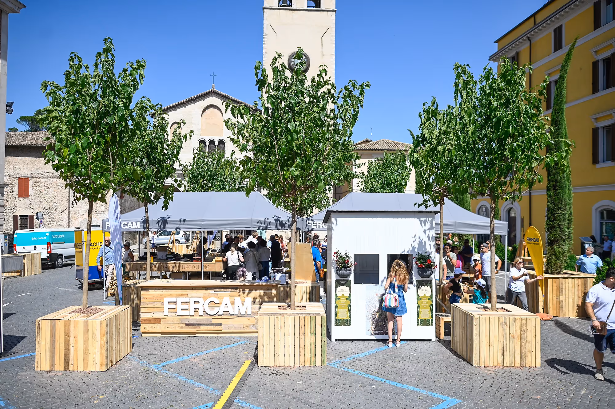Festival di Spoleto event with white tents and wooden booths in historic city center