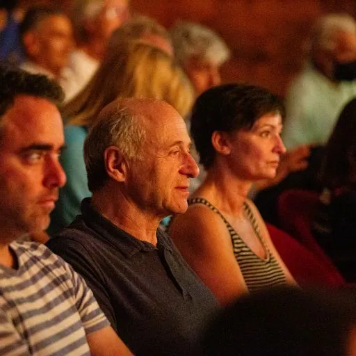 Audience members at Festival di Spoleto enjoying a cultural performance together