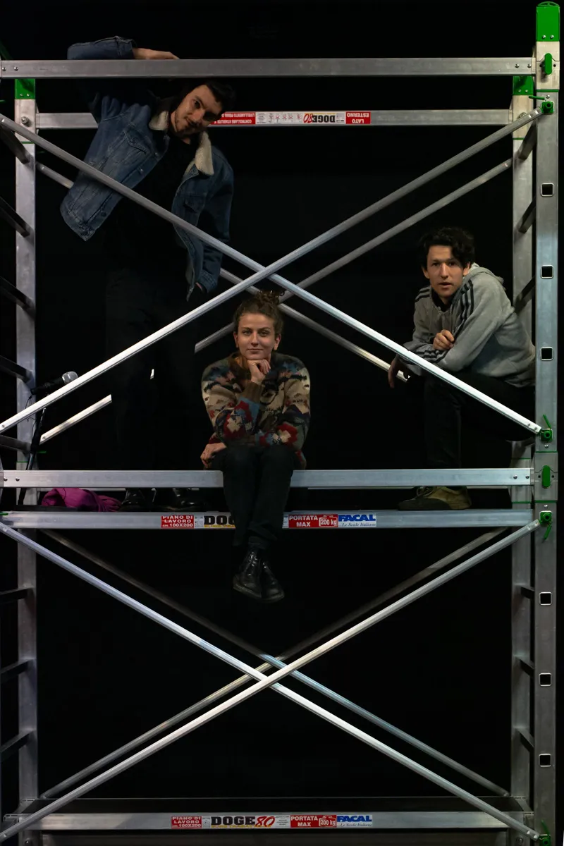 Festival di Spoleto performers posing on industrial metallic scaffolding structure
