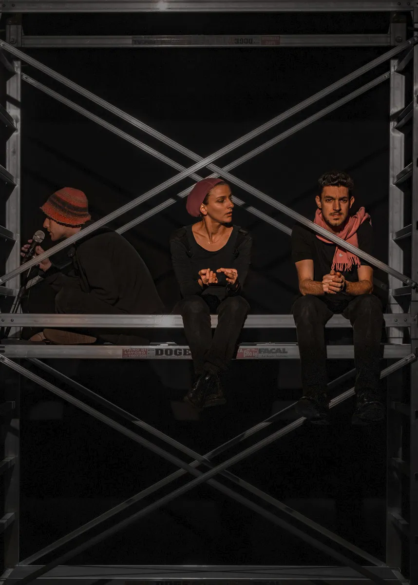 Festival di Spoleto performers pose dramatically on industrial scaffolding backdrop