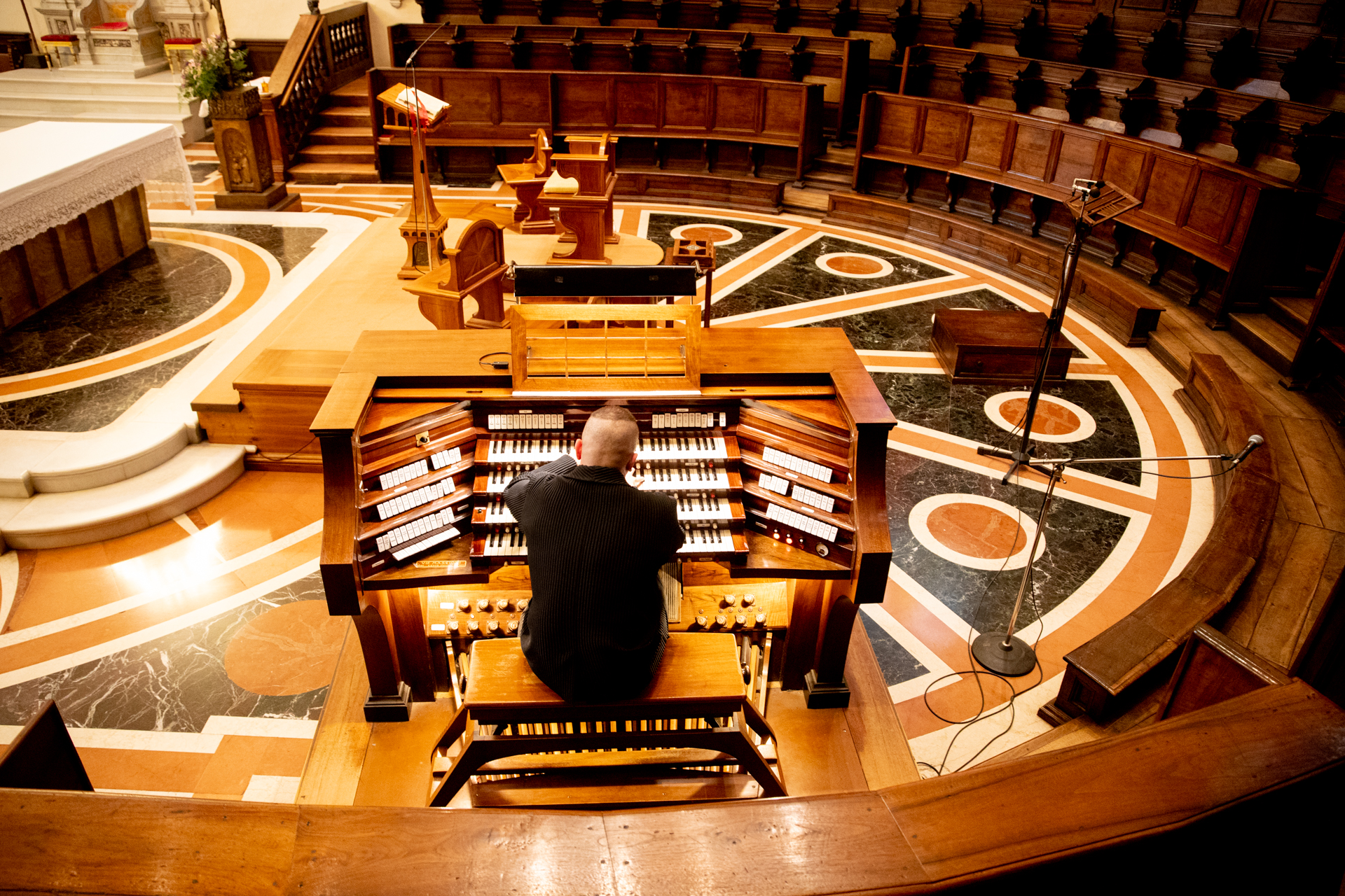 Organist at Festival di Spoleto performing on ornate wooden stage