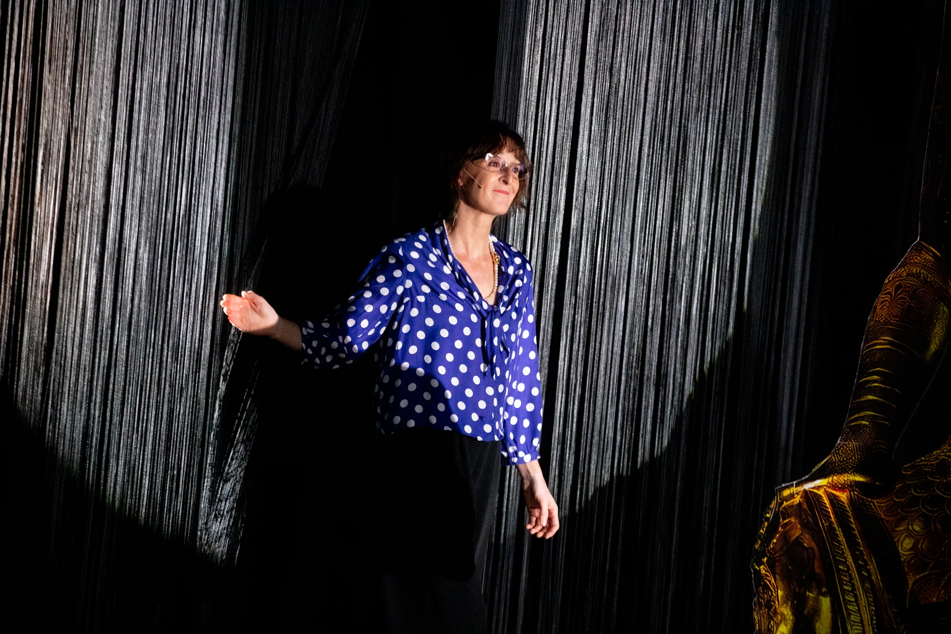 Performer in blue polka dot top at Festival di Spoleto theatrical stage