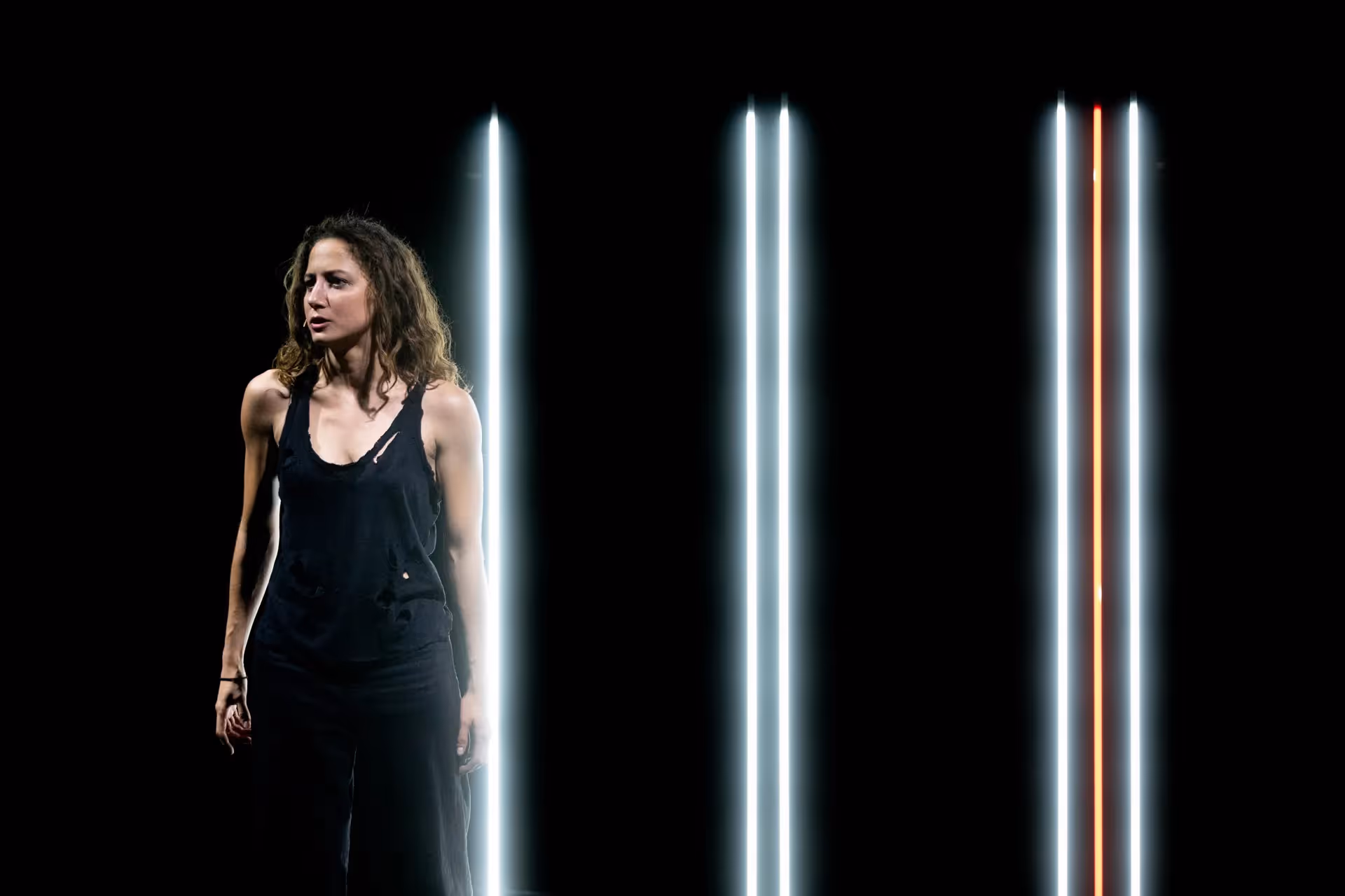 Performer at Festival di Spoleto with dramatic lighting and vertical lines