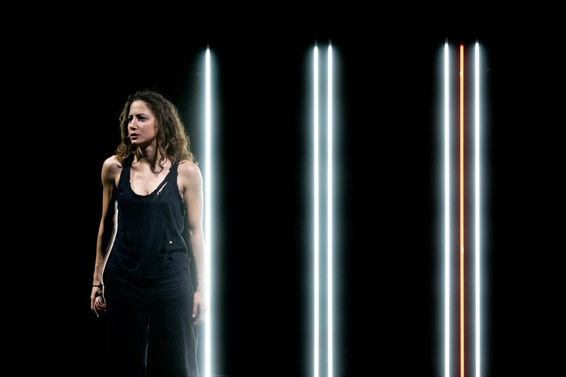 Performer at Festival di Spoleto with dramatic lighting and vertical lines