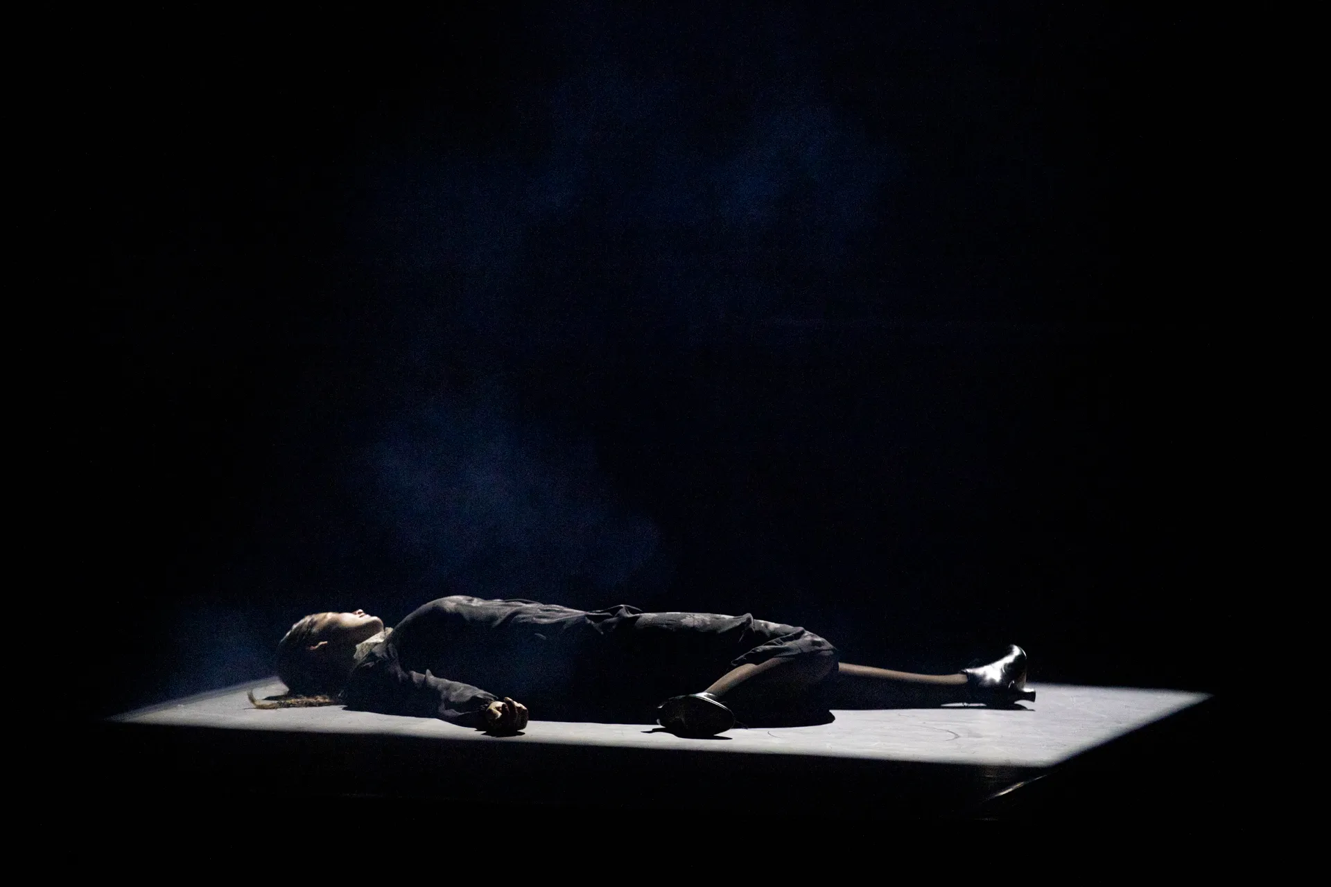 Dramatic performance at Festival di Spoleto, figure lying on illuminated stage