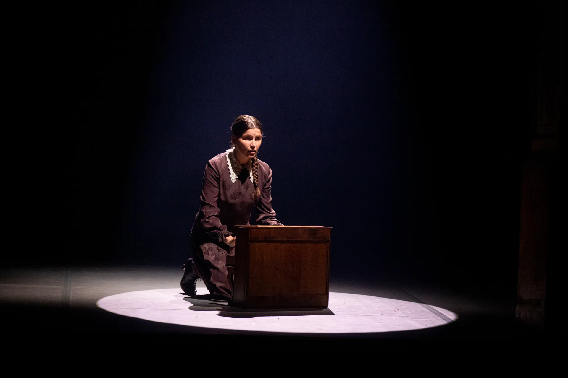 Performer on stage at Festival di Spoleto, illuminated in dramatic spotlight