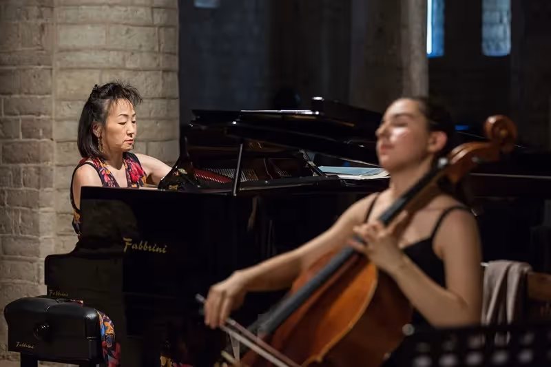 Festival di Spoleto musicians performing piano and cello in stone-walled venue