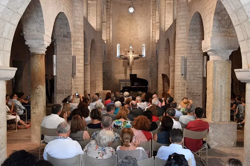 Festival di Spoleto concert in historic stone church with audience and grand piano