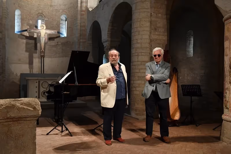 Festival di Spoleto musicians pose in historic stone venue with piano