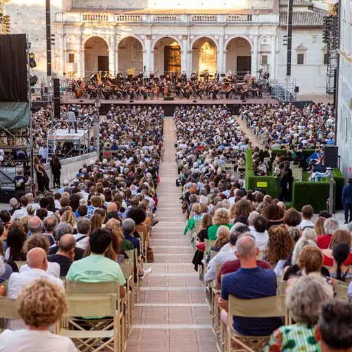 Crowded orchestra performance at Festival di Spoleto in historic Italian square