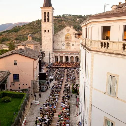 Crowded Festival di Spoleto outdoor concert in historic Italian cathedral square