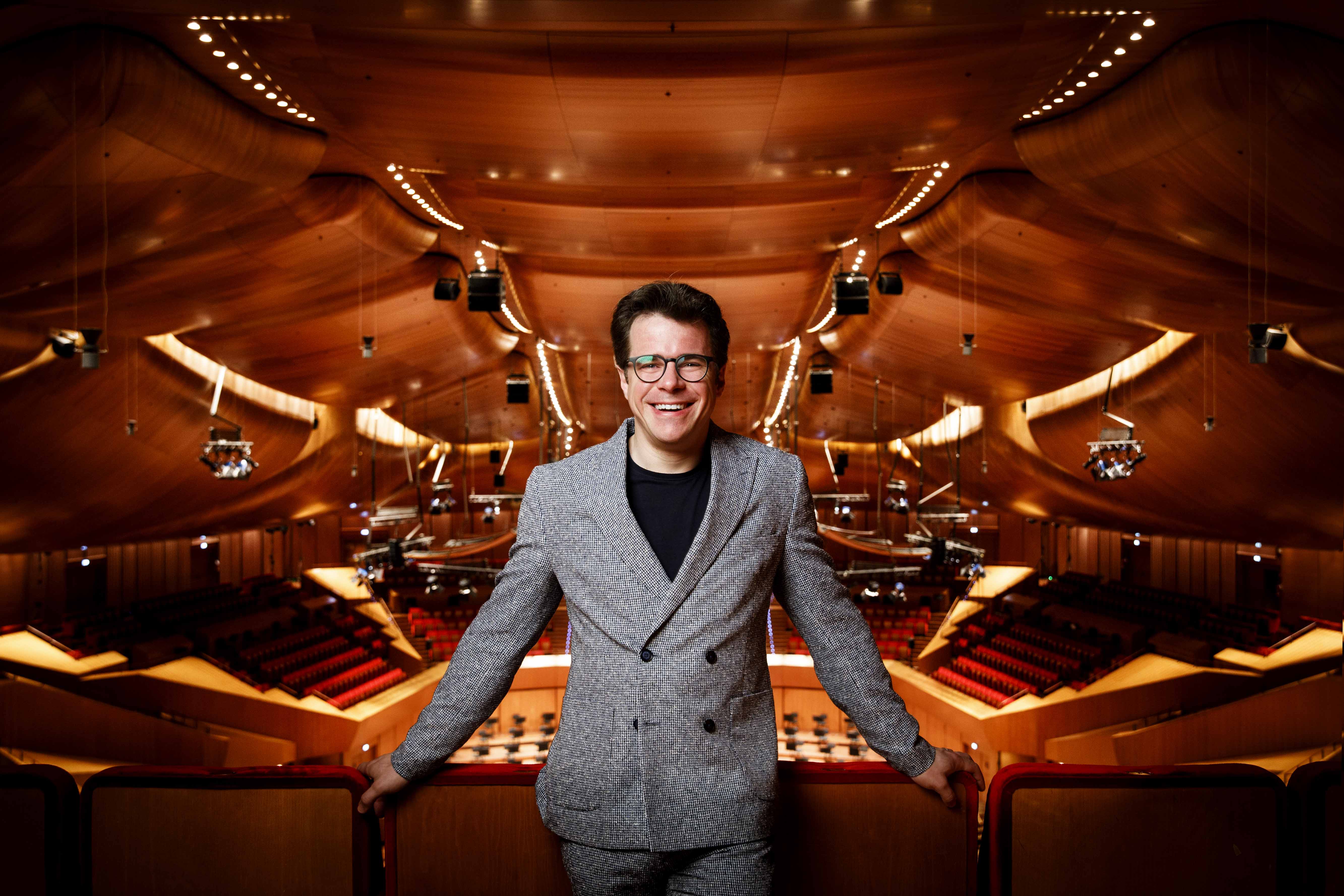 Festival di Spoleto artistic director poses in elegant concert hall