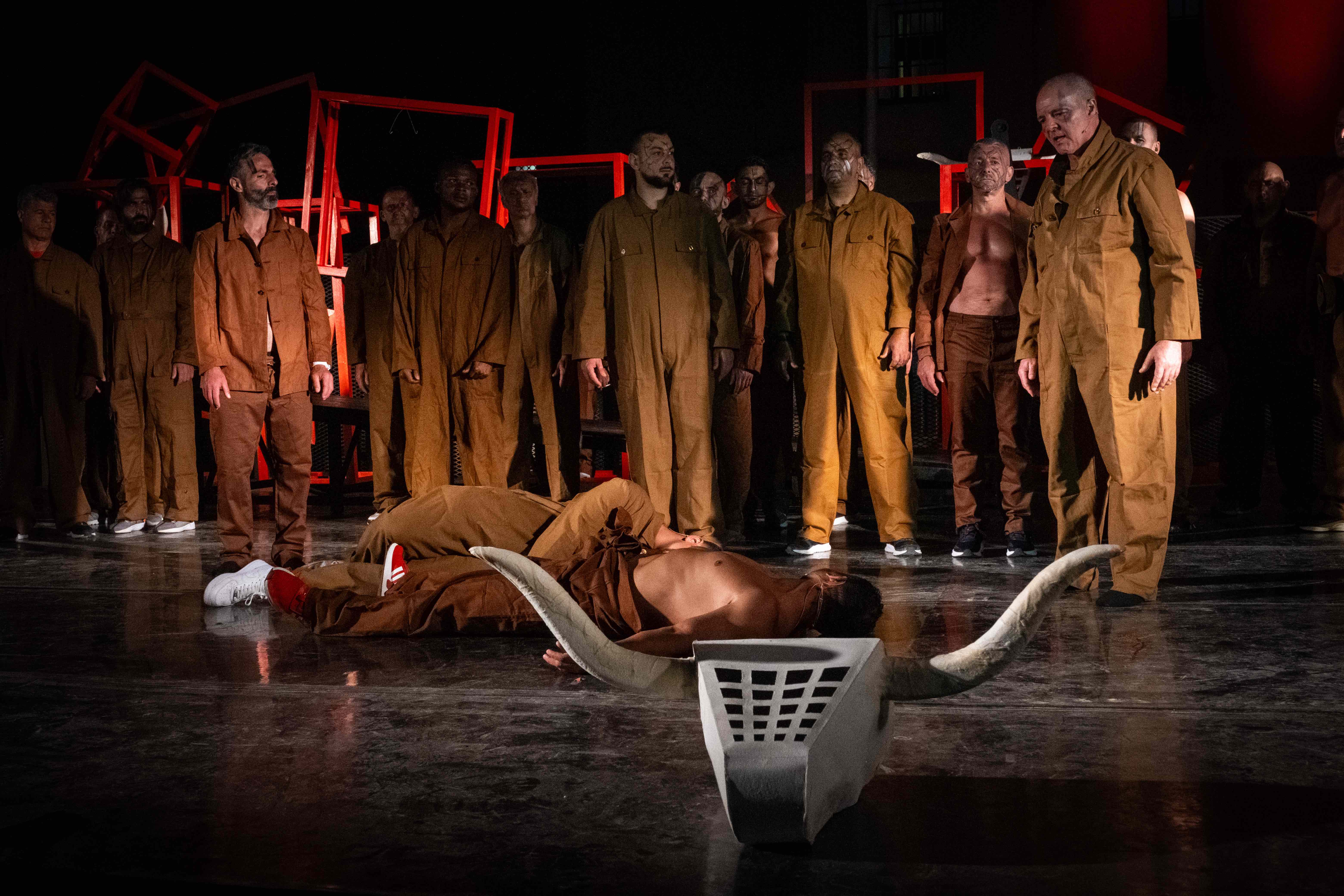 Festival di Spoleto theatrical performance with dramatic staging and performers in brown uniforms