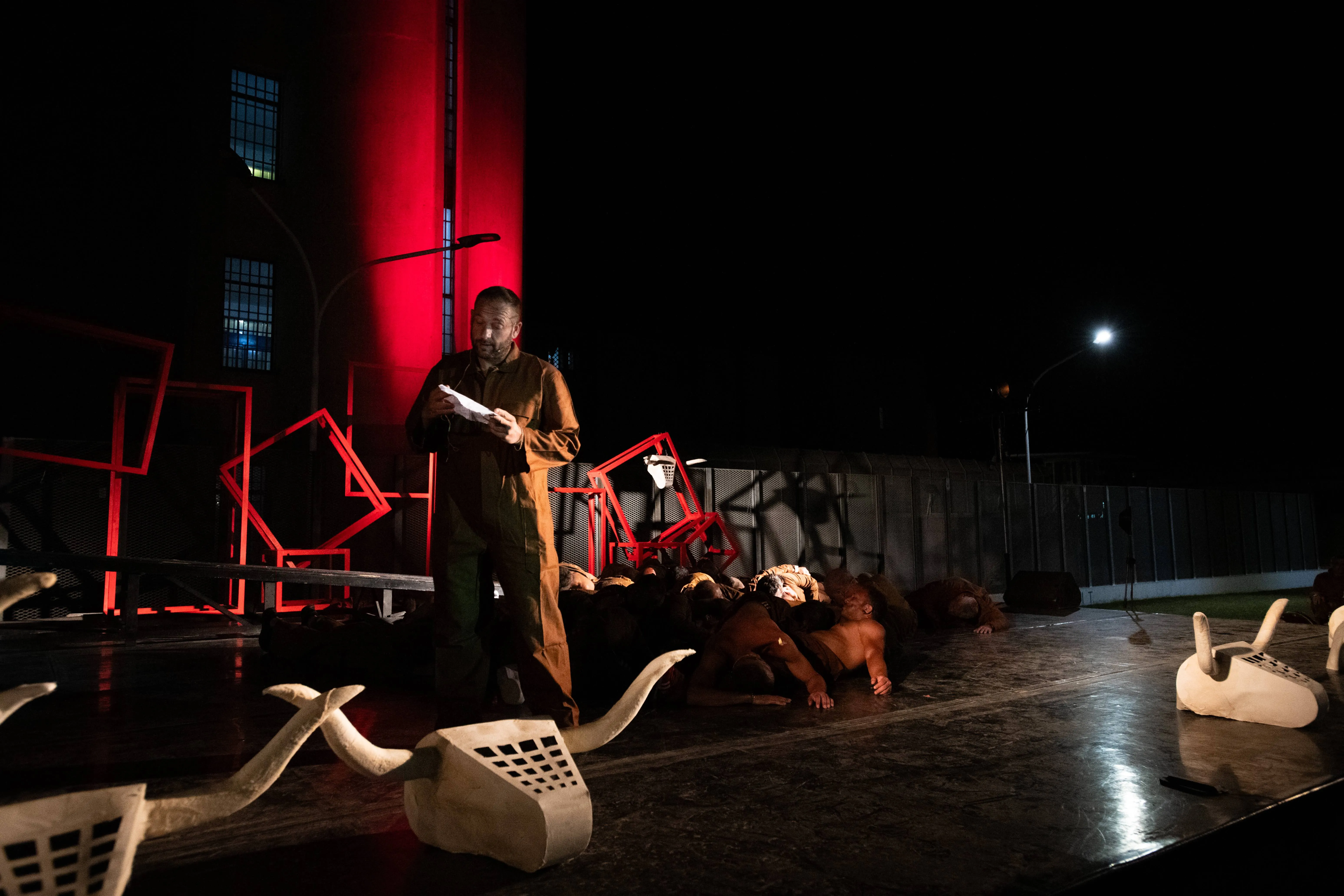 Performance art scene at Festival di Spoleto with dramatic red lighting
