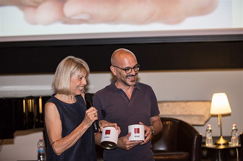 Festival di Spoleto event with two people holding branded coffee mugs