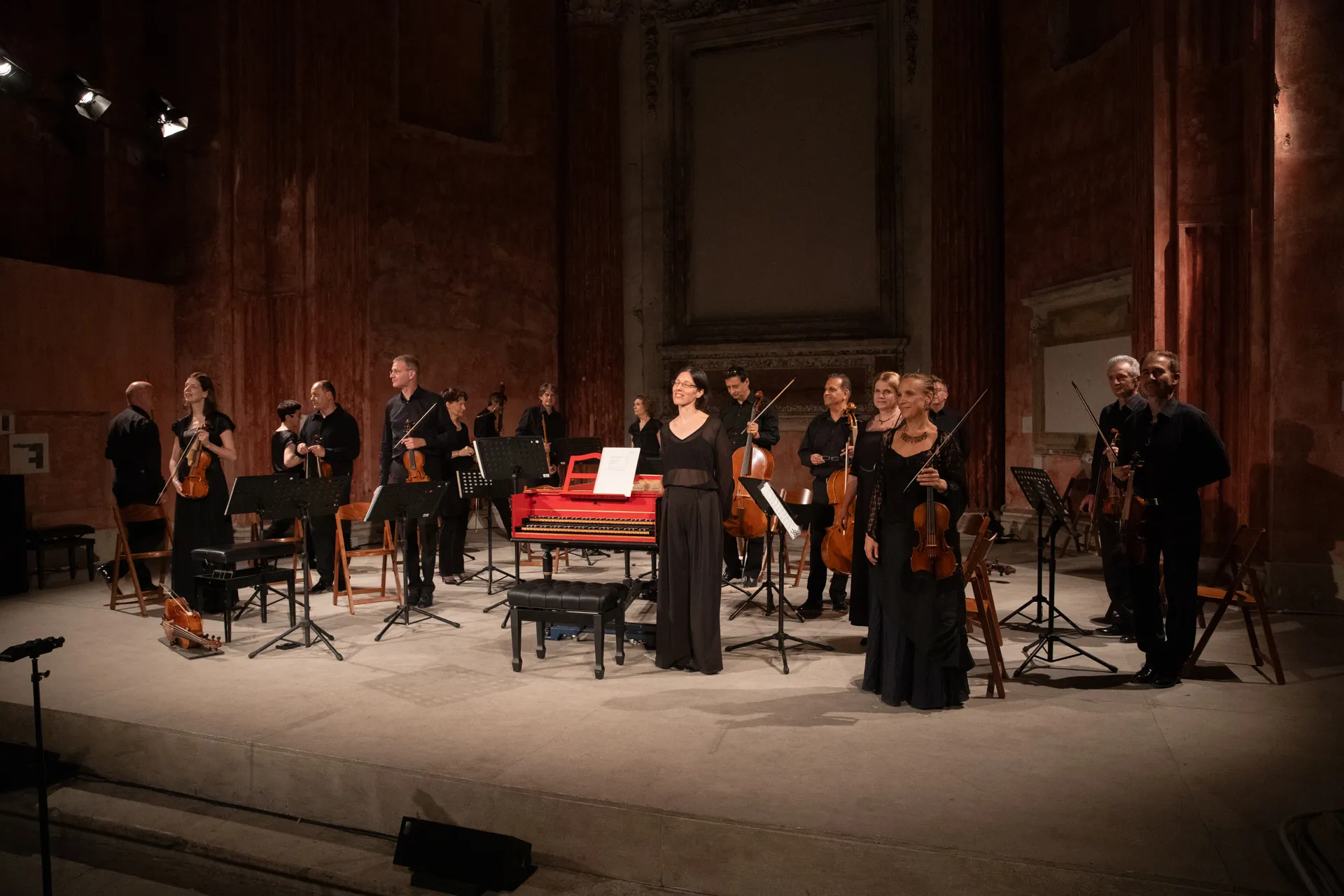 Festival di Spoleto classical orchestra performing with red harpsichord on stage