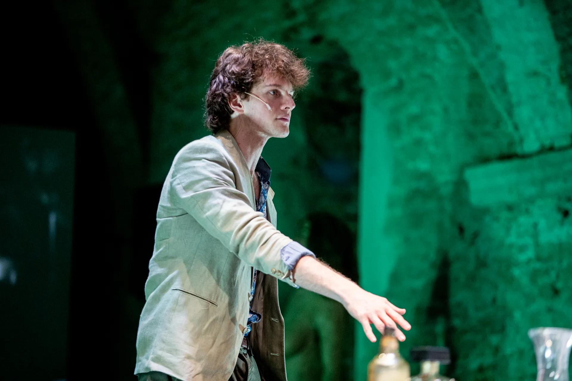 Performance at Festival di Spoleto with performer in white jacket on green stage