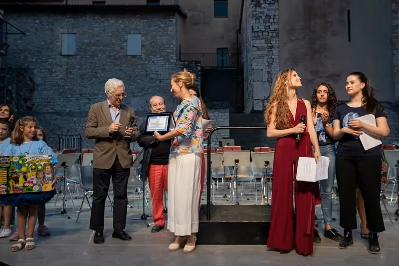 Award ceremony at Festival di Spoleto with people on stone stage
