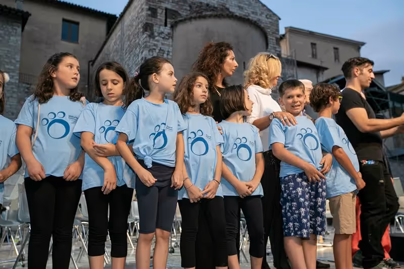 Young performers at Festival di Spoleto, lined up in matching blue shirts