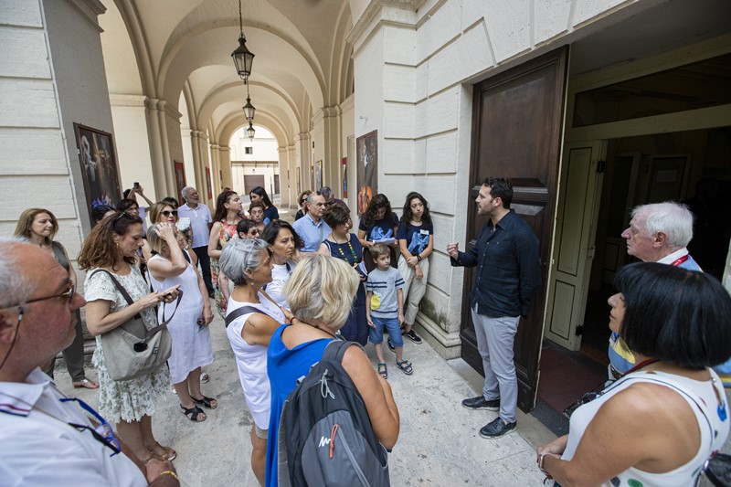 Festival di Spoleto visitors gather in historic arched corridor during cultural event