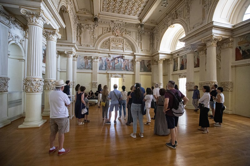 Visitors explore elegant hall during Festival di Spoleto cultural event