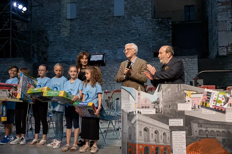 Festival di Spoleto event with children and speakers at historic stone venue