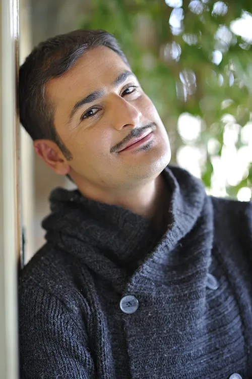 Festival di Spoleto portrait of artist in cozy knit sweater near greenery