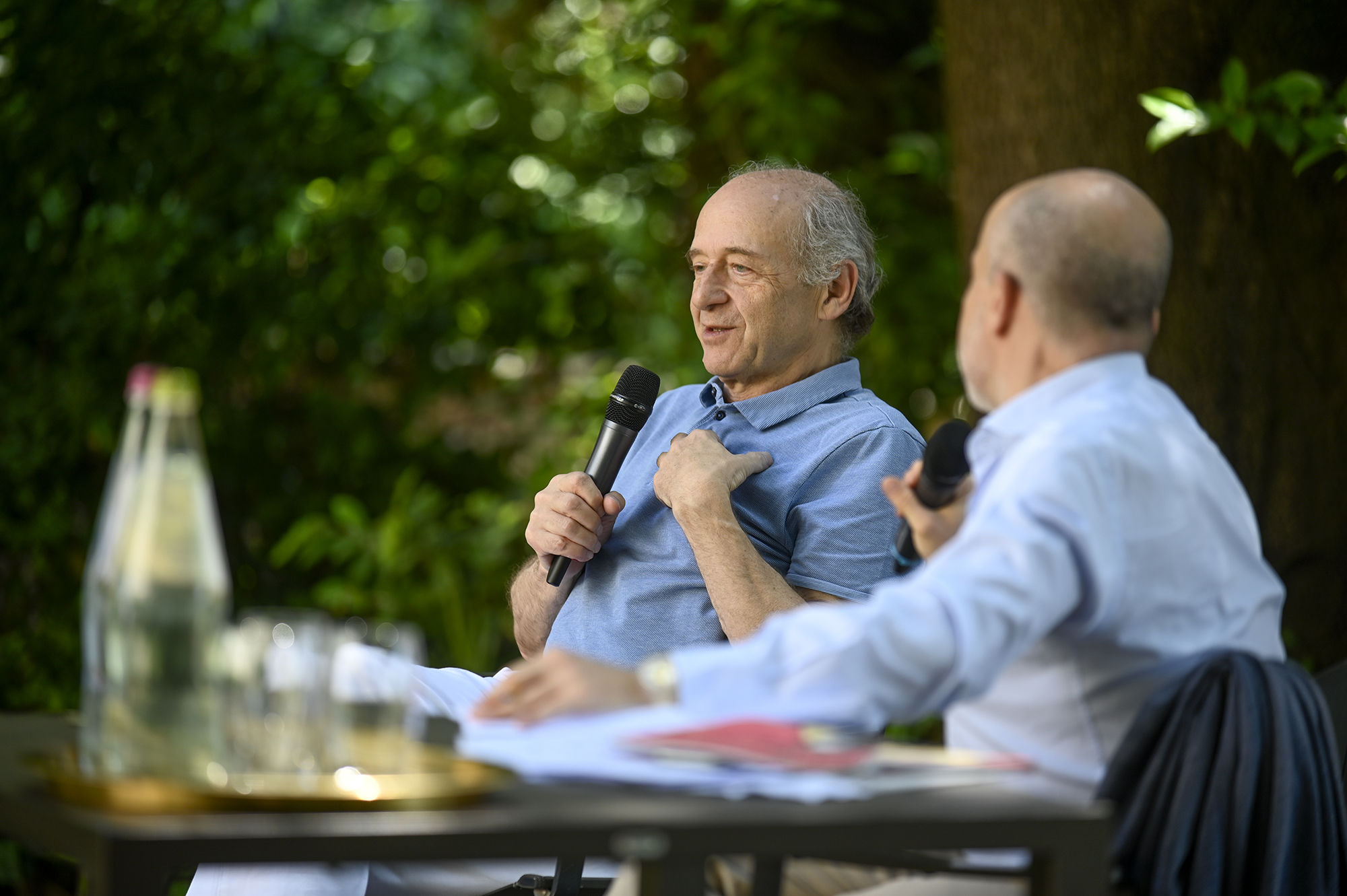 Two speakers discussing at Festival di Spoleto cultural event outdoors