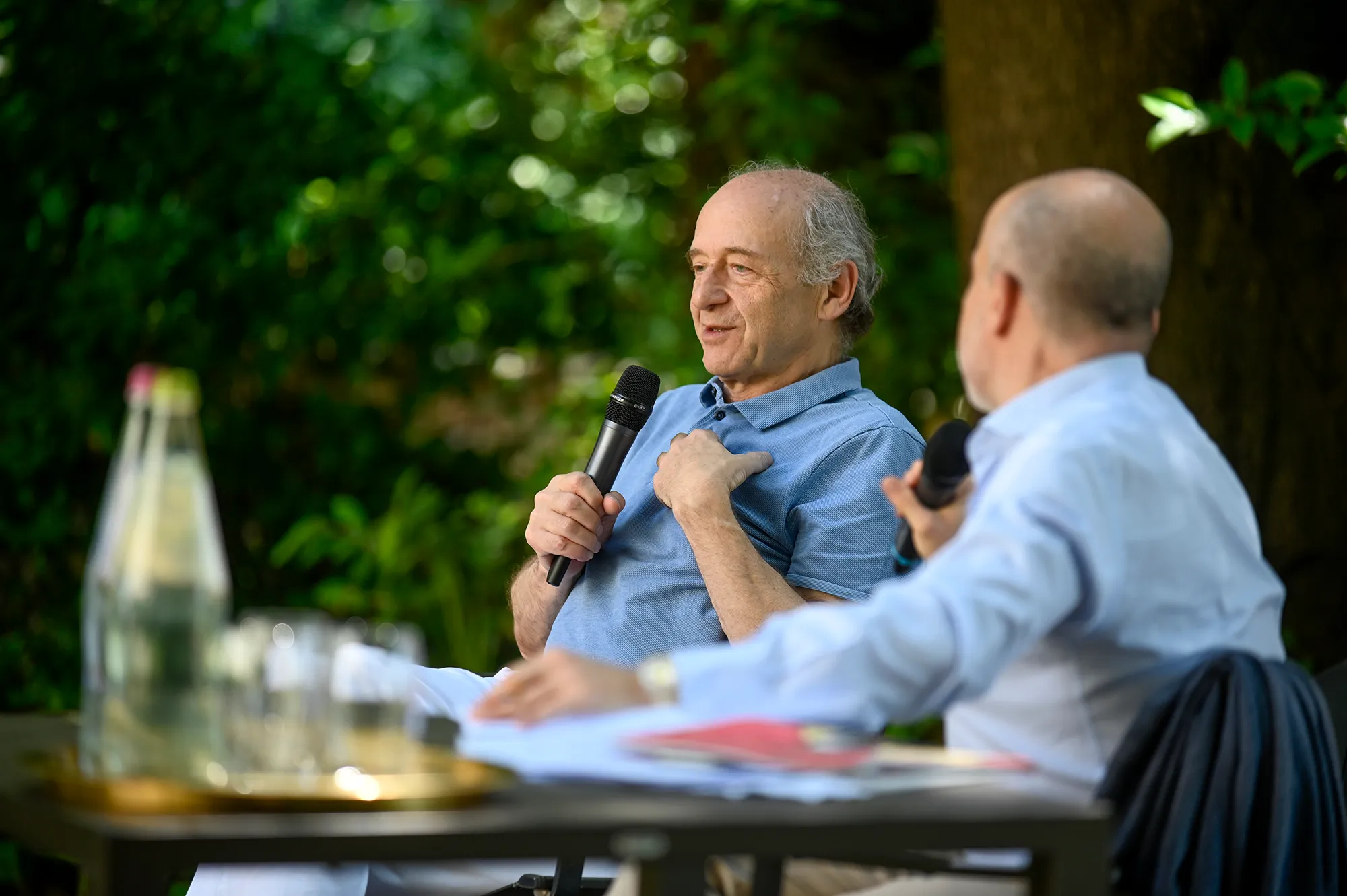 Two speakers discussing at Festival di Spoleto cultural event outdoors