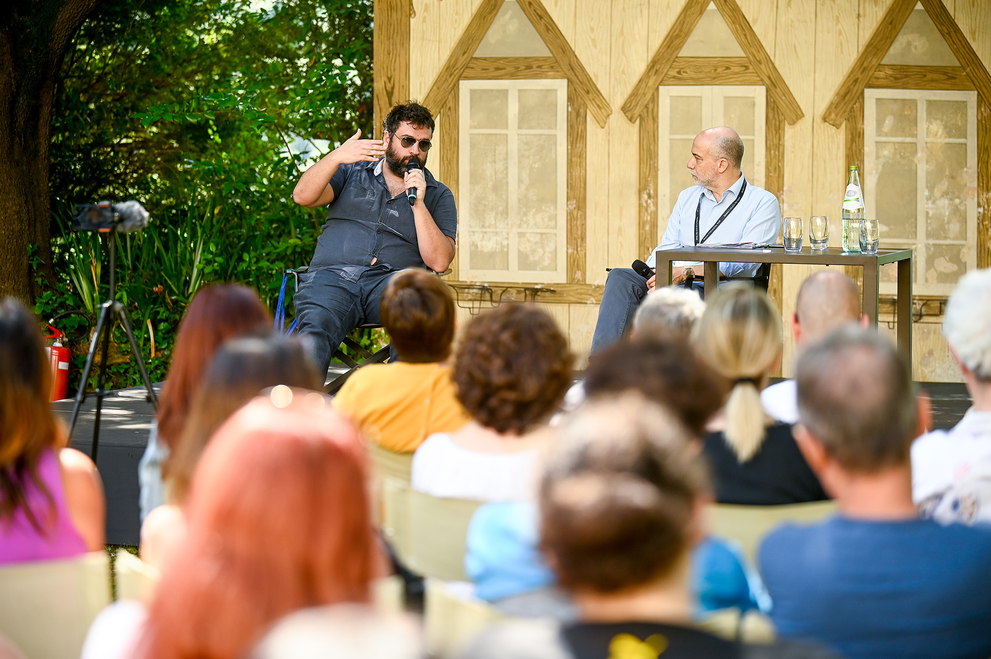 Speaker presenting at Festival di Spoleto cultural event with engaged audience