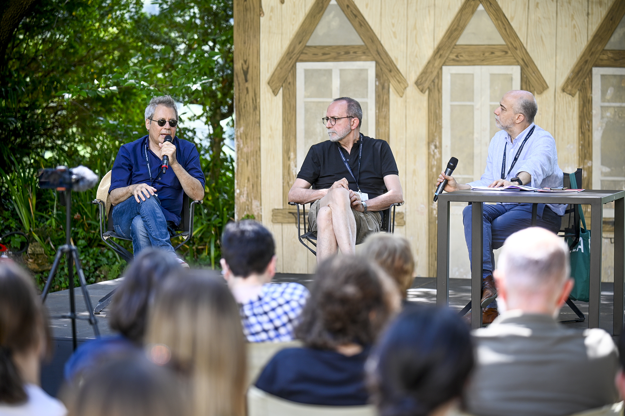 Festival di Spoleto panel discussion with three speakers addressing audience outdoors