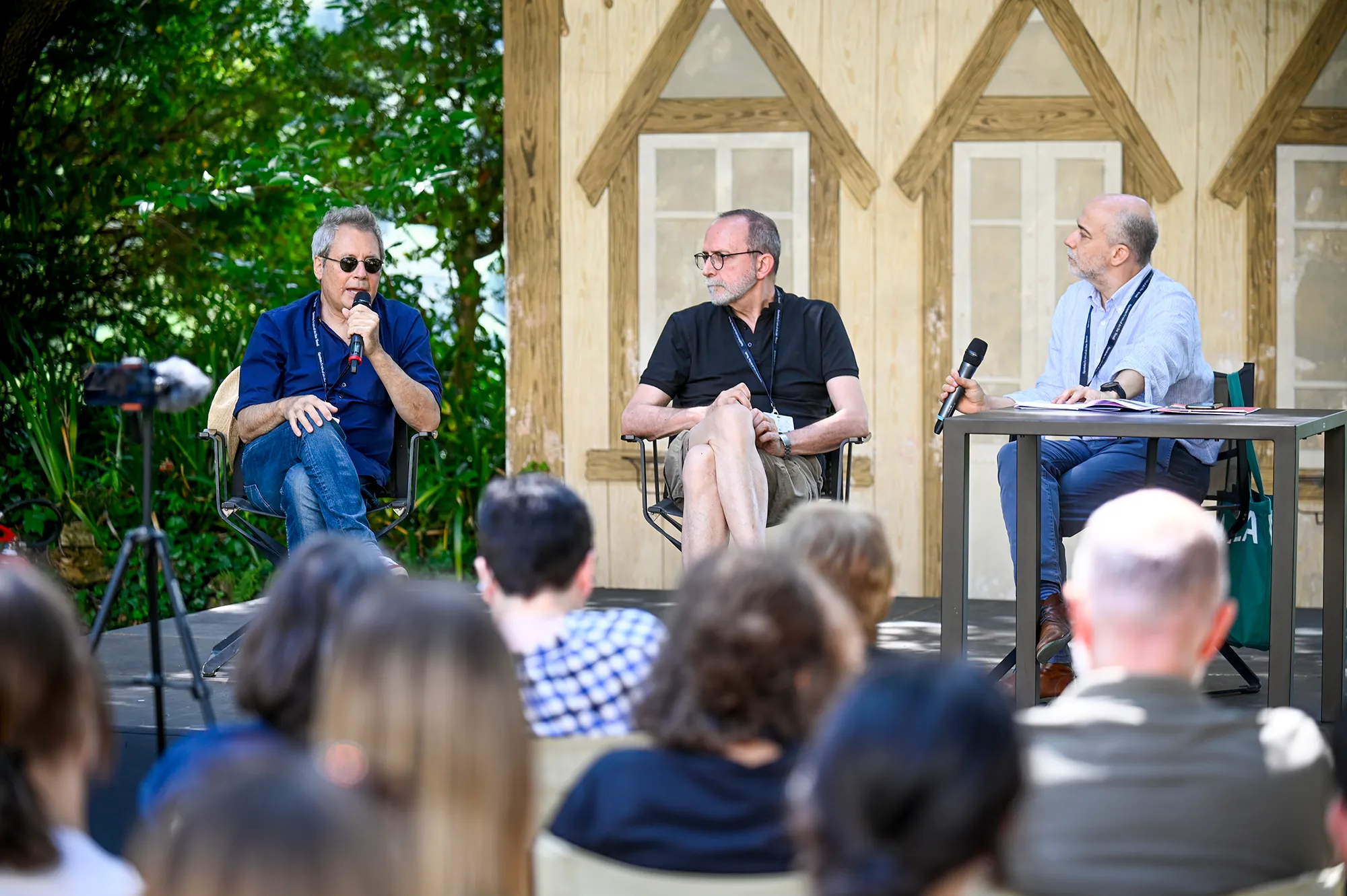 Festival di Spoleto panel discussion with three speakers addressing audience outdoors