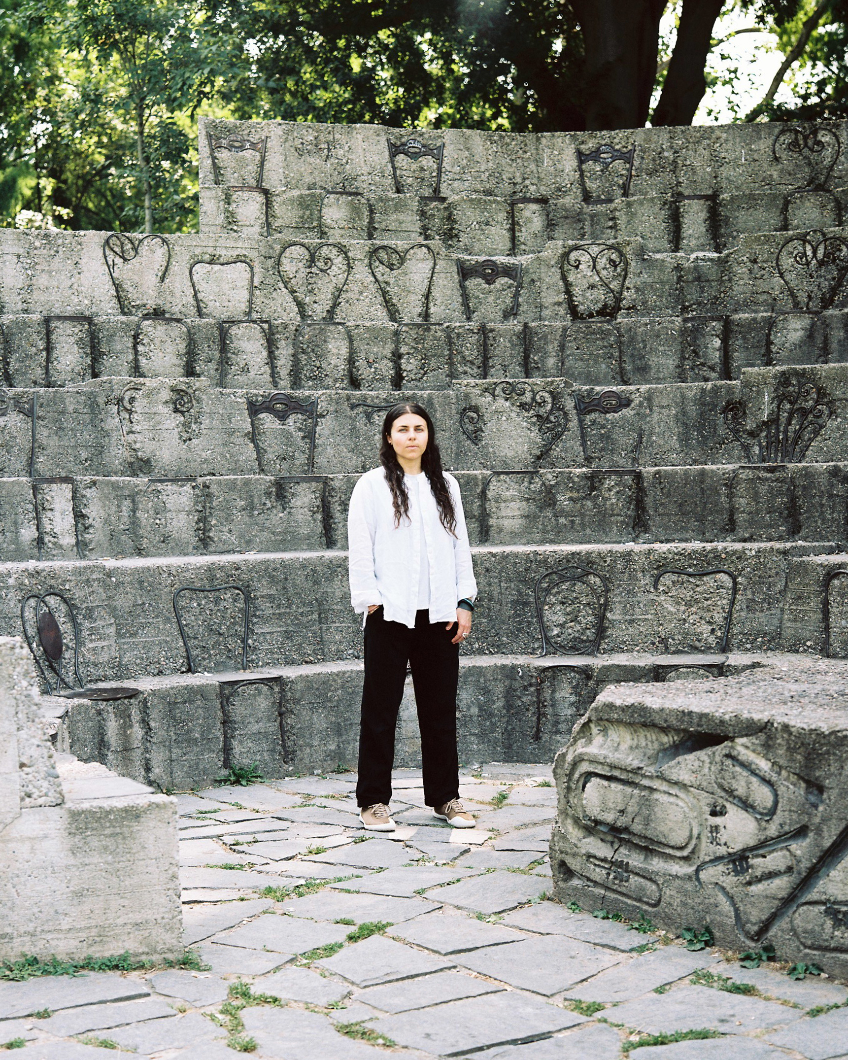 Person standing at stone amphitheater during Festival di Spoleto event