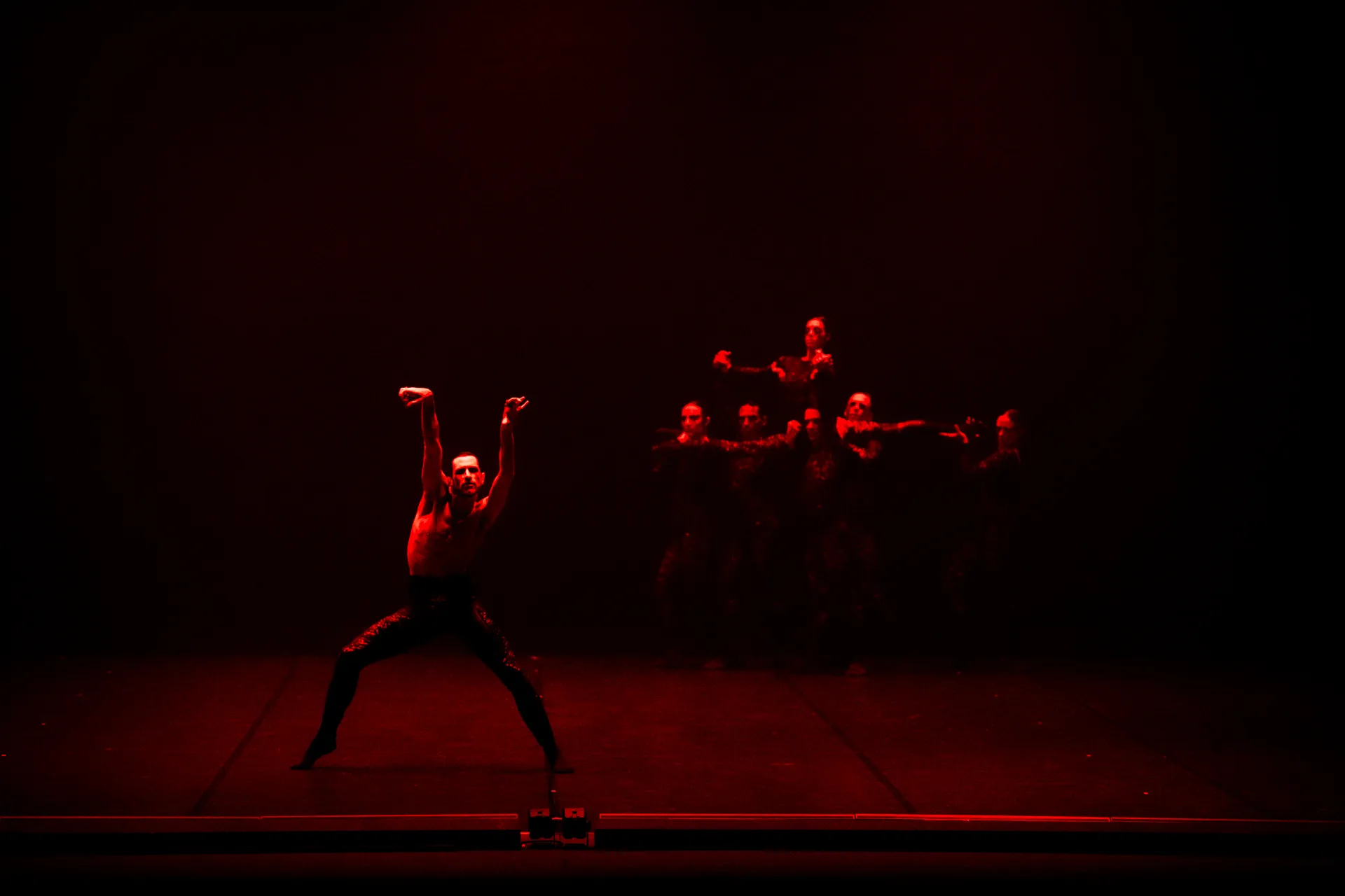 Festival di Spoleto dramatic performance with dancers in intense red lighting