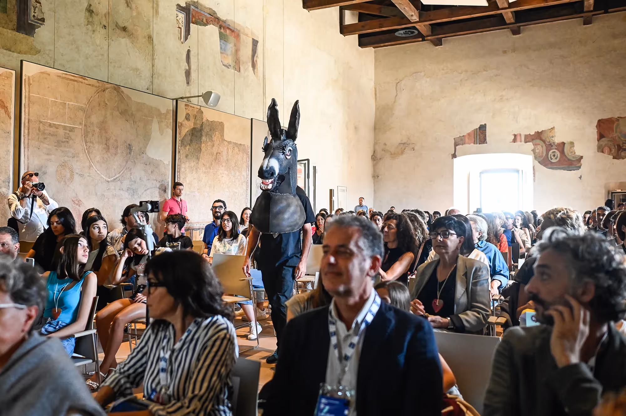 Festival di Spoleto event with surreal donkey sculpture among audience members