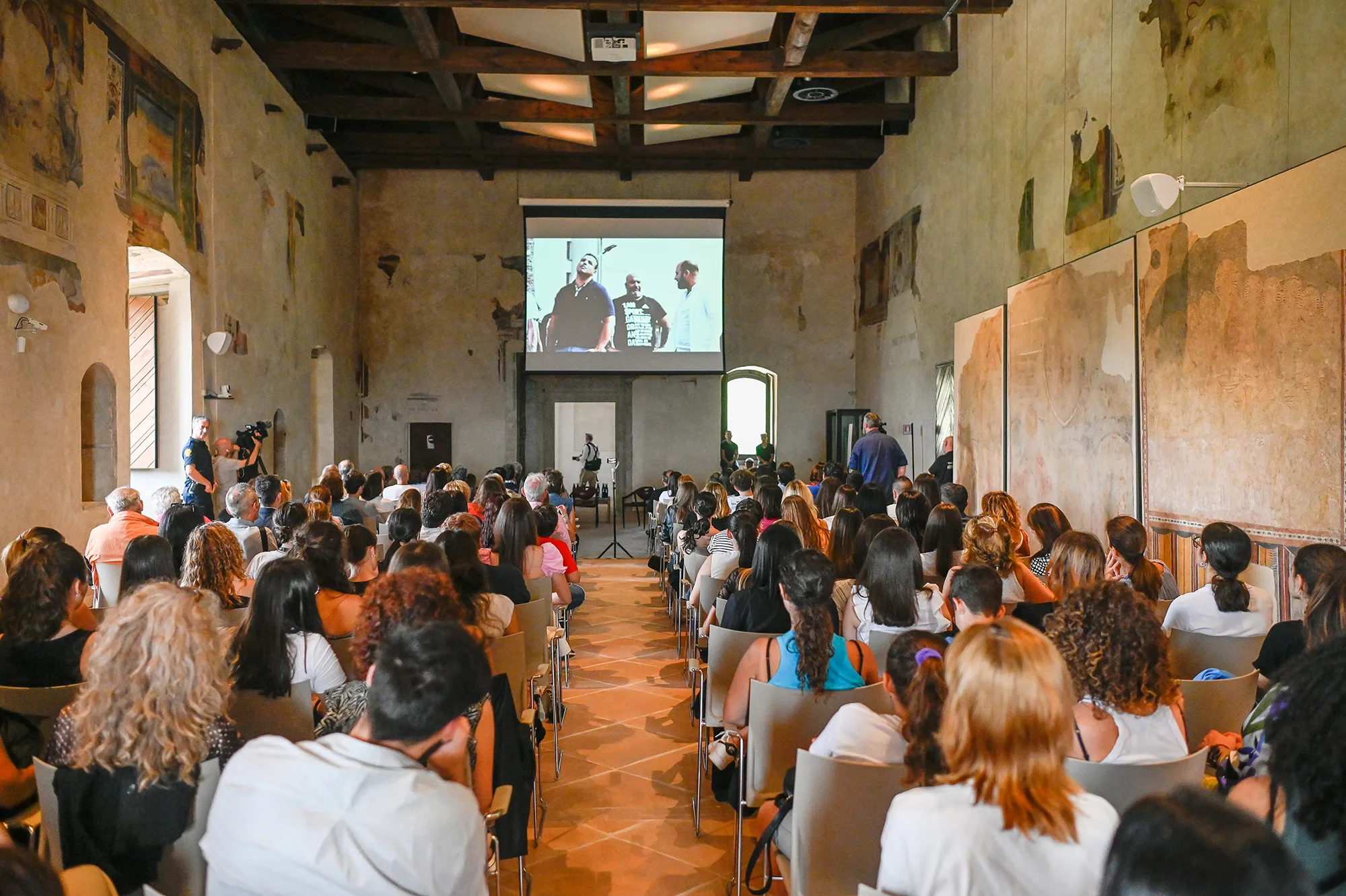 Festival di Spoleto event with audience watching presentation in historic venue