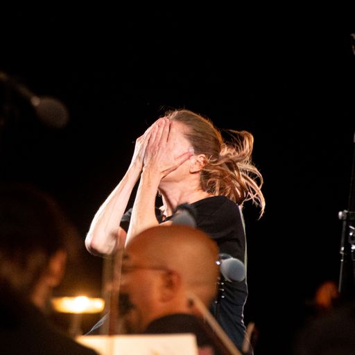 Emotional performer at Festival di Spoleto covering face during intense moment